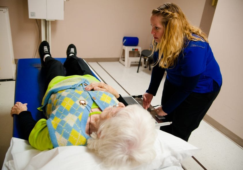 X-ray technician positions elderly patient for imaging OrthoEdge Orthopedic Specialists Jacksonville Florida ortho edge fl